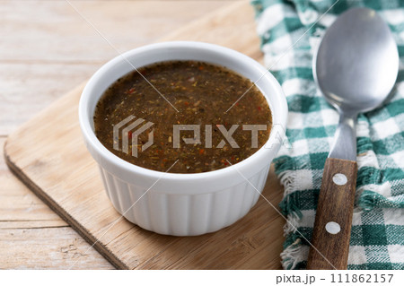 Green Chimichurri Sauce on wooden table Green Chimichurri Sauce on wooden table 111862157