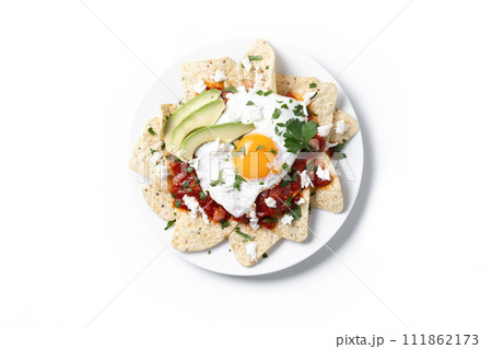 Traditional Mexican breakfast red chilaquiles with egg isolated on white background Traditional Mexican breakfast red chilaquiles with egg isolated on white background 111862173