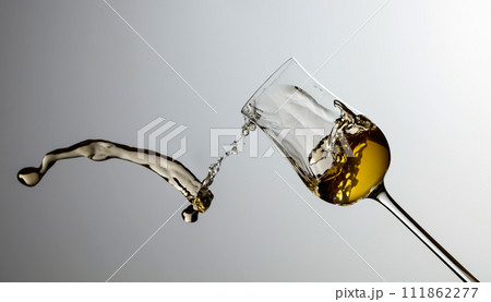 The drink spills out of the glass. 111862277