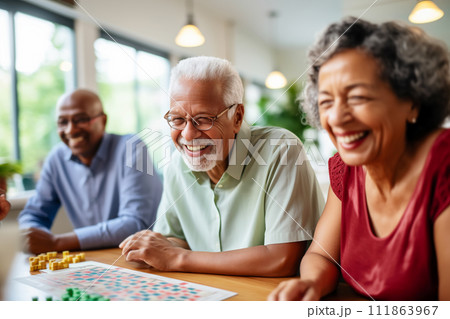 AI-generated content. Multiracial seniors having fun during board game in geriatric clinic or nursing home AI-generated content. Multiracial seniors having fun during board game in geriatric clinic or nursing home 111863967