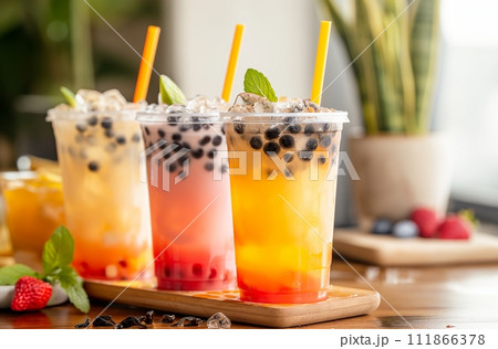 AI-generated content. A vibrant selection of fruity and tapioca bubble tea flavors, served with colorful straws in clear cups garnished with fresh mint leaves 111866378