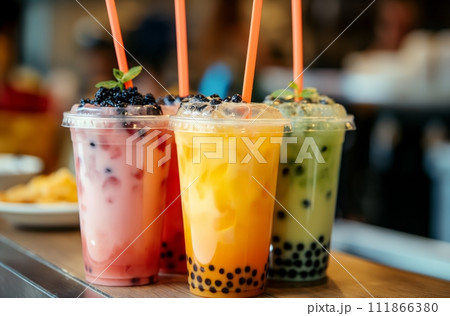 AI-generated content. Three colorful bubble tea drinks in a row, featuring pink, yellow, and green hues with tapioca, garnished with fruit toppings, and ready-to-drink with straws 111866380