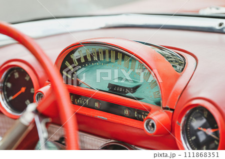 Interior of a red vintage car and speedometer 111868351