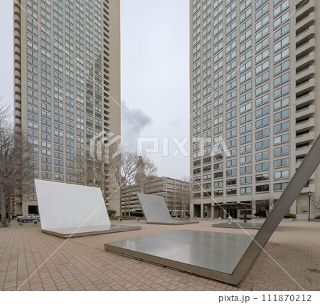 Cloudy view of a big metal decoration in front of an apartment 111870212