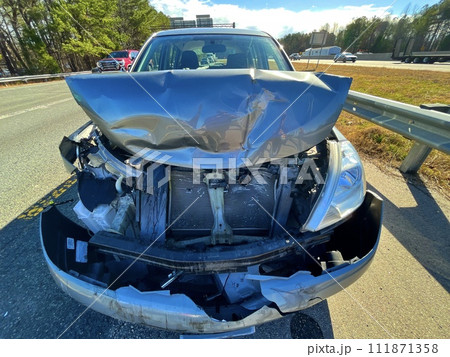 wrecked auto on the side of a road wrecked auto on the side of a road 111871358