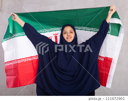 Young woman in hijab posing with Iran flag Young woman in hijab posing with Iran flag 111872901
