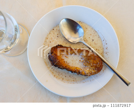 Sweet Spanish Easter torrija de leche served with creamy sauce 111872917