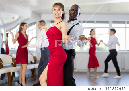 Woman dances incendiary boogie woogie with African man partner during choreography lesson Woman dances incendiary boogie woogie with African man partner during choreography lesson 111872932