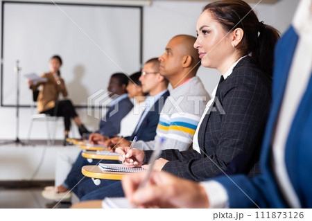 Female entrepreneur sitting in conference room at business training Female entrepreneur sitting in conference room at business training 111873126