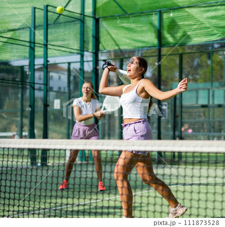 Two women tennis players playing padel 111873528
