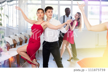 Young guy and adult woman dance tango 111873739