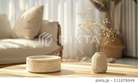 Ceramic cosmetic jar with dried flowers on table in living room 111878049