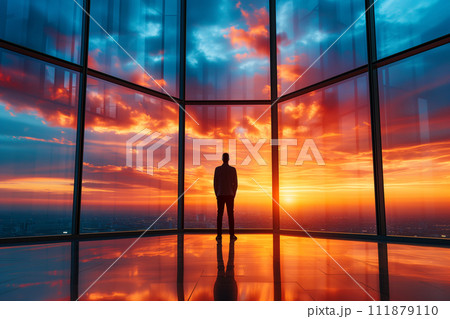 A contemplative businessman stands silhouetted against a vibrant sunset, the golden hues reflecting off the glossy floor of a modern office building, overlooking a bustling cityscape. A contemplative businessman stands silhouetted against a vibrant sunset, the golden hues reflecting off the glossy floor of a modern office building, overlooking a bustling cityscape. 111879110