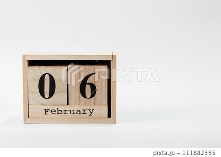 Wooden calendar February 06 on a white background 111882385