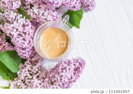 freshly brewed cup of coffee among vibrant lilac blossoms, capturing essence of tranquil spring morning freshly brewed cup of coffee among vibrant lilac blossoms, capturing essence of tranquil spring morning 111882807