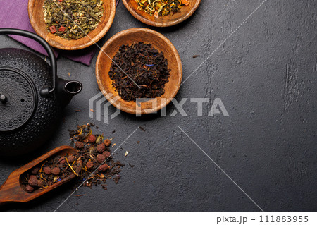 A collection of various teas nestled in wooden bowls 111883955