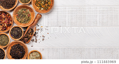 A collection of various teas nestled in wooden bowls A collection of various teas nestled in wooden bowls 111883969