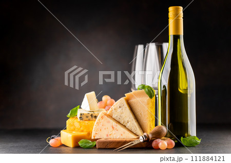 Various cheese on board and white wine 111884121