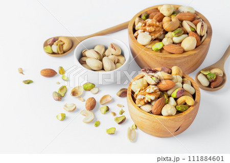 Mixed nuts in wooden bowl isolated on white background 111884601