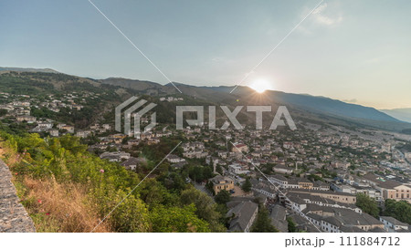 Panorama showing sunset over Gjirokastra city from the viewpoint of the fortress of the Ottoman castle of Gjirokaster timelapse. 111884712
