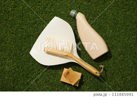 Brush, scoop, bottle and soap green background, top view 111885091