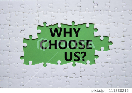 Why choose us symbol. Concept words Why choose us on white puzzle. Beautiful green background. Business and Why choose us concept. Copy space. 111888213