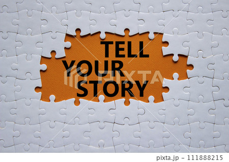 Tell your story symbol. Concept words Tell your story on white puzzle. Beautiful orange background. Business and Tell your story concept. Copy space. 111888215