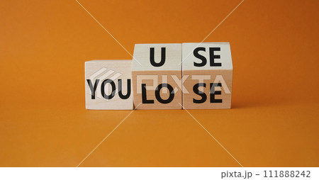You use or lose symbol. Turned wooden cubes with words You lose or You use. Beautiful orange background. Business and You use or lose concept. Copy space You use or lose symbol. Turned wooden cubes with words You lose or You use. Beautiful orange background. Business and You use or lose concept. Copy space 111888242