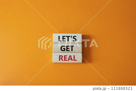 Lets get real symbol. Concept words Lets get real on wooden blocks. Beautiful orange background. Business and Lets get real concept. Copy space. 111888321