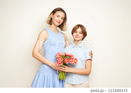 Boy gives his mother flowers 111888335