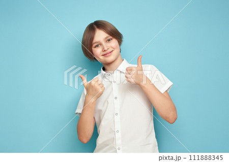 Smiling cheerful child showing thumbs up 111888345