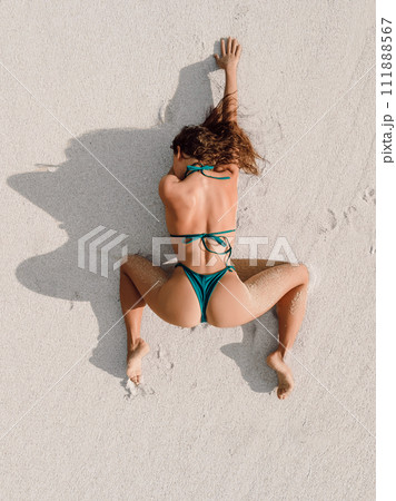 Aerial drone view of sexy slim woman in bikini on beach. 111888567