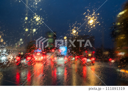 Blurred Traffic Lights Through Rainy Windshield 111891319