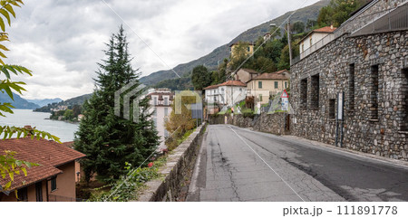 Street in village Musso-Dongo at lake Como, where the dictator Mussolini became imprisoned through a road blockade 111891778