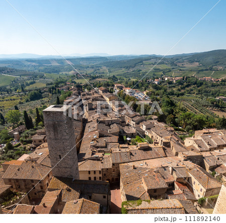 Wide panoramic view over downtown San Gimignano and Torre Ficarelli, seen from Torre Grosso Wide panoramic view over downtown San Gimignano and Torre Ficarelli, seen from Torre Grosso 111892140