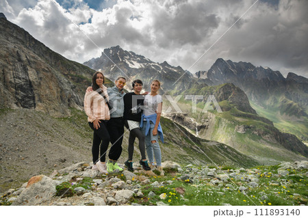 A group of friends climbed high in the mountains A group of friends climbed high in the mountains 111893140