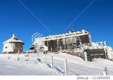 Wooden building of new post office and Roman catholic chapel in snezka, mountain on the border between Czech Republic and Poland, winter morning 111893695