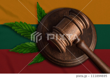 Justice wooden gavel with cannabis leaf on the Flag of Lithuania. Illegal growth of cannabis plant and drugs spreading 111894695