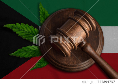 Justice wooden gavel with cannabis leaf on the Flag of Kuwait. Illegal growth of cannabis plant and drugs spreading 111894737