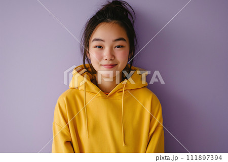 Asian happy teenage girl wearing hoodie on purple background 111897394