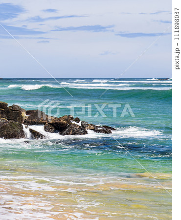 Scenic tropical beach and sky with clouds. Vertical photo. Scenic tropical beach and sky with clouds. Vertical photo. 111898037