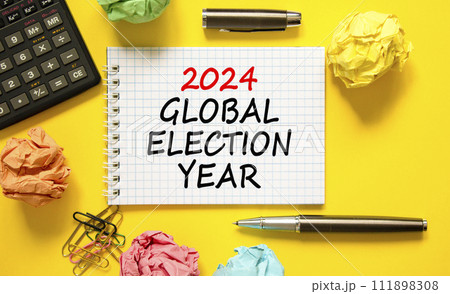 2024 global election year symbol. Concept words 2024 global election year on beautiful white note. Beautiful yellow background. Calculator. Business 2024 global election year concept. Copy space 2024 global election year symbol. Concept words 2024 global election year on beautiful white note. Beautiful yellow background. Calculator. Business 2024 global election year concept. Copy space 111898308