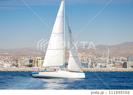 Sailing boat with Limassol marina on background. Limassol, Cyprus 111898508