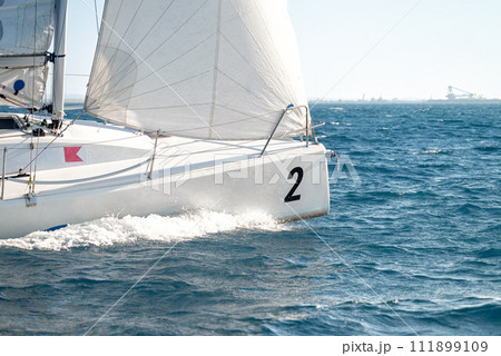 Sailboat under white sails during the regatta competition 111899109