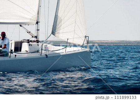 Side view of a sailing yacht during regatta in open sea 111899133