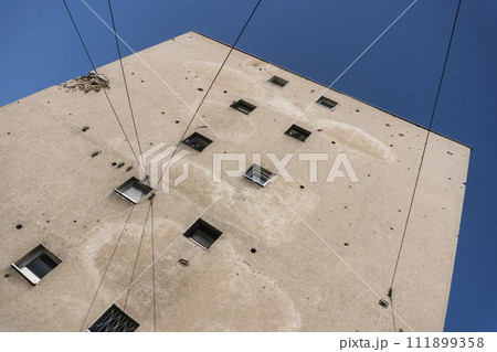 Bullet holes in a house after shooting, bombing and shelling during the War in Sarajevo, Bosnia and Herzegovina 111899358