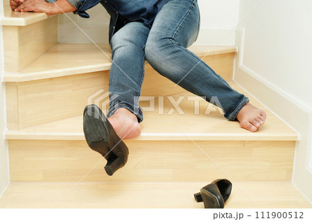 Asian business woman pain ankle, foot with leg cramp and fall down the stairs because slippery surfaces in office. 111900512