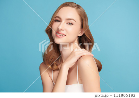 Beautiful young woman with clean fresh skin on blue background, Face care, Facial treatment, Cosmetology, beauty and spa, women portrait. Beautiful young woman with clean fresh skin on blue background, Face care, Facial treatment, Cosmetology, beauty and spa, women portrait. 111905192