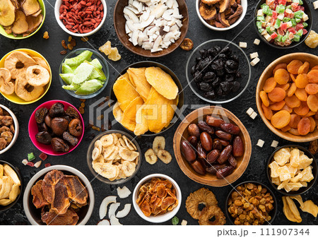 Assorted organic healthy dried sweet berries and fruits snack in various bowl plates Assorted organic healthy dried sweet berries and fruits snack in various bowl plates 111907344