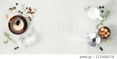 Flat lay with Moka pot, espresso cup, ground coffee, milk, sugar and coffee beans on a grey concrete background 111908278